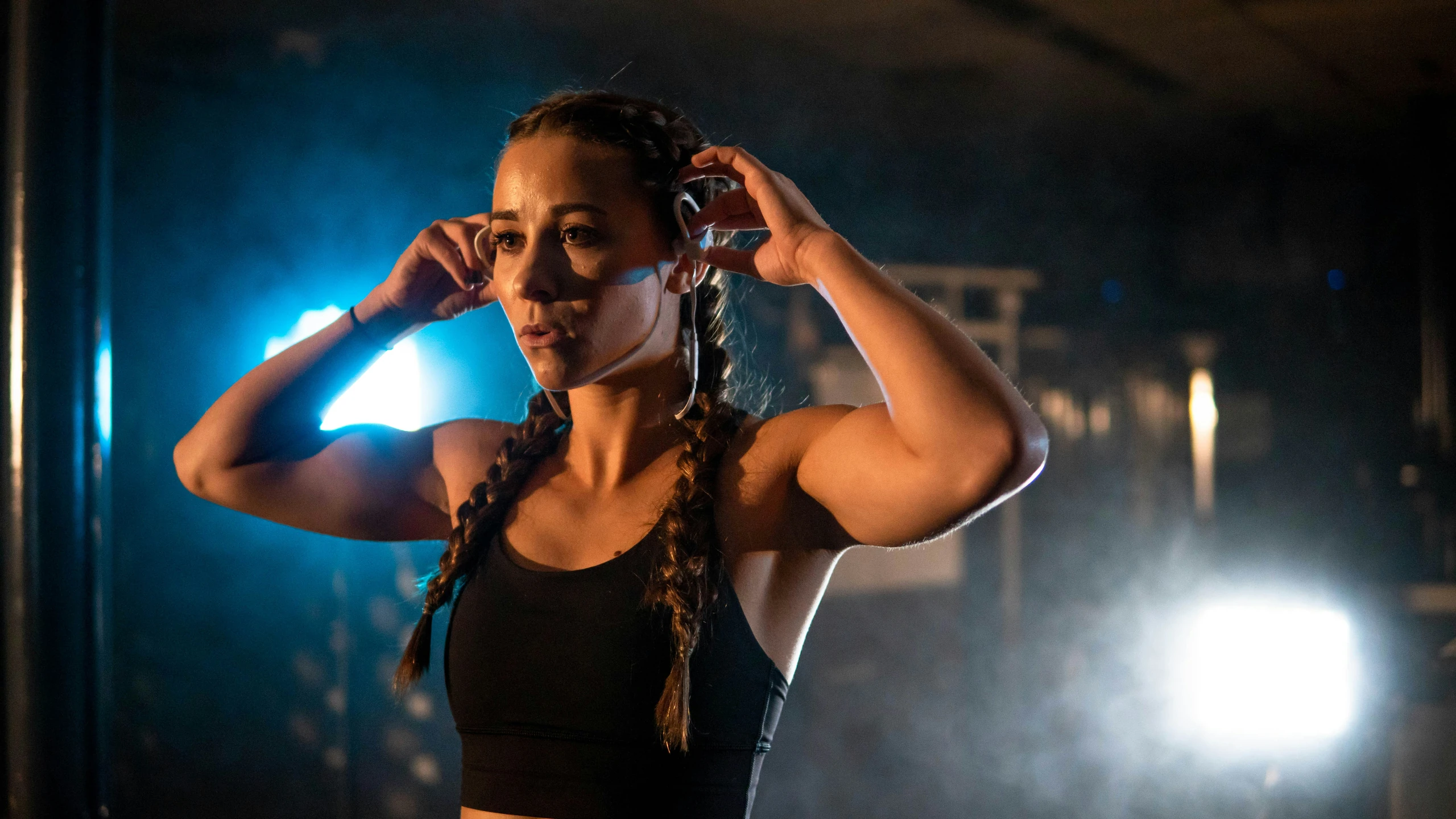 Woman putting on sport earphones before a workout